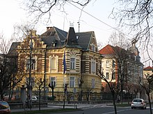 The Mladika Complex (in the back) houses part of the offices of the Ministry. In front of it stands the villa of the Austrian Embassy in Ljubljana. Ljubljana (5746734150).jpg