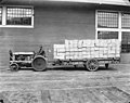 Man on tractor pulling a trailer loaded with lumber, Bloedel-Donovan Lumber Mills, ca 1922-1923 (INDOCC 1099).jpg