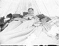 Man sleeping inside a tent (3946086014).jpg
