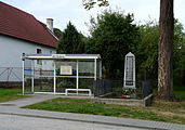 Čeština: Zastávka autobusu a pomník v obci Netřebice v okrese Český Krumlov, Jihočeský kraj. English: Bus shelter and a memorial in the village of Netřebice, Český Krumlov District, South Bohemian Region, Czech Republic.