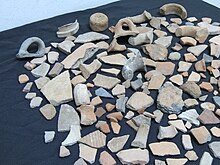 Collection of potsherds and loom weight taken from different ruins. Potsherds discovered in Israel.jpg