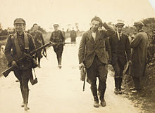 Irish Army soldiers escorting a captured IRA member Prisoner (6417469255).jpg