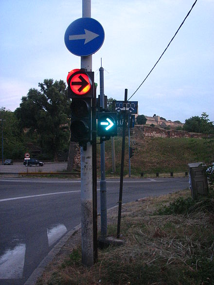 "Right turn on red" traffic light in Belgrade, Serbia. Right turn only after pedestrians and traffic pass from left.