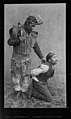 Shaman standing, holding witch in kneeling position, Alaska, circa 1886-1890 (AL+CA 6087).jpg