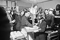 Tea and buns are supplied by local Air Raid Precautions (ARP) workers to fellow ARP workers and civilians in this basement shelter in South East London during 1940. D1623.jpg