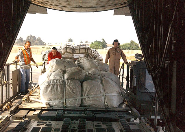Fleet Logistics Support Squadron Six Four (VR-64) helps to load 463L master pallets of food, and re-building supplies donated by the government of The