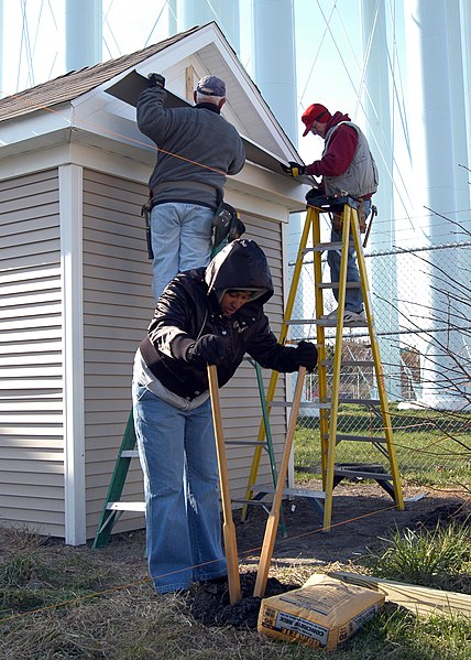 File:US Navy 080221-N-7127A-003 Aviation Boatswain's Mate Handler Airman Carmen Wynes digs a hole for a post of a new fence in the backyard of a new home built by Sailors and volunteers participating in a Habitat for Humanity projec.jpg