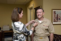 Vice Adm. Bruce E. MacDonald is pinned with his new rank by his wife, Karen, on August 4, 2008.