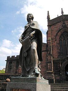 Statue of Wulfrun bearing her charter, on the church steps, by Charles Wheeler Wolverhampton St Peters - Wulfrun 01.jpg