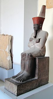 An Osiride statue of the first pharaoh of the Middle Kingdom, Mentuhotep II; 2061–2010 BC; painted sandstone; 138 × 47 cm; Egyptian Museum (Cairo)