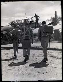 Members of a torpedo bomber crew prepare to leave from Bougainville air strip on a strike at Rabaul.  In center is the pilot; to his left is the turret gunner; to right, radio-gunner.