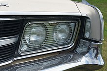 Glass-covered 5 3/4 " sealed beam headlamps on a 1965 Chrysler 300 1965 Chrysler 300 (14754183459).jpg