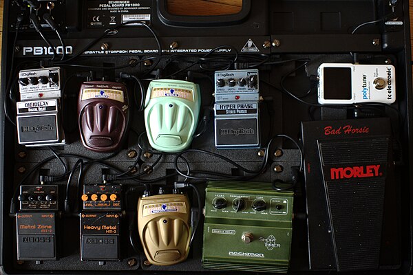 An example of an effects chain. From the input [right] to the output [left]: Tuner [upper right] (tc electronic Polytune) ⇒Wah pedal [lower right] (Morley Bad Horsie Wah) ⇒Overdrives/distortion [lower row] (Rocktron Short Timer Delay → Danelectro CTO-1 Transparent Overdrive → Boss HM-2 → Boss MT-2) ⇒Modulations/delay [upper row] (Digitech Hyper Phase → Danelectro CV-1 Vibe → Danelectro CT Tremolo → Digitech Hyper Delay)