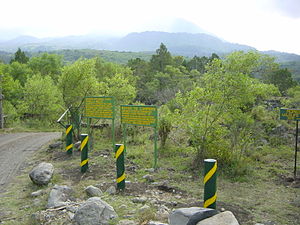 At the entrance to Arusha National Park, with Mount Meru in the background