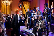 President Obama and King singing "Sweet Home Chicago" on February 21, 2012 Barack Obama singing in the East Room.jpg