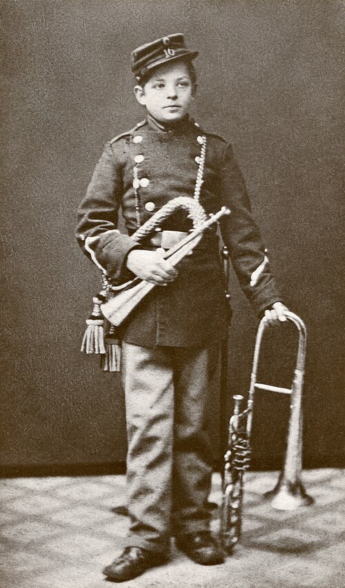 Carl Nielsen aged 14 in band uniform with bugle and valve alto trombone, Denmark, 1879.