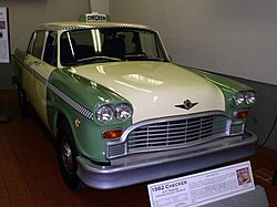 The last Checker Taxicab built, a 1982 A11 in green and cream with Checker's trademark checkerboard trim, on display at the Gilmore Car Museum in Hickory Corners, Michigan Checker A-11 Taxicab 1982.jpg