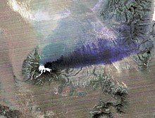 An ASTER night time thermal infrared image capturing 2015 eruption of Calbuco Volcano in Chile. Hot eruptive material at the summit appears in white (hot), with a purple plume streaming to the right, indicating that it is ash-laden. Chilean Volcanic Eruption Nighttime View.jpg