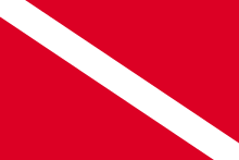 The "Diver Down" flag, flown from a dive boat, warns surface watercraft when divers are in the water. See Diver down flag. Diver Down Flag.svg