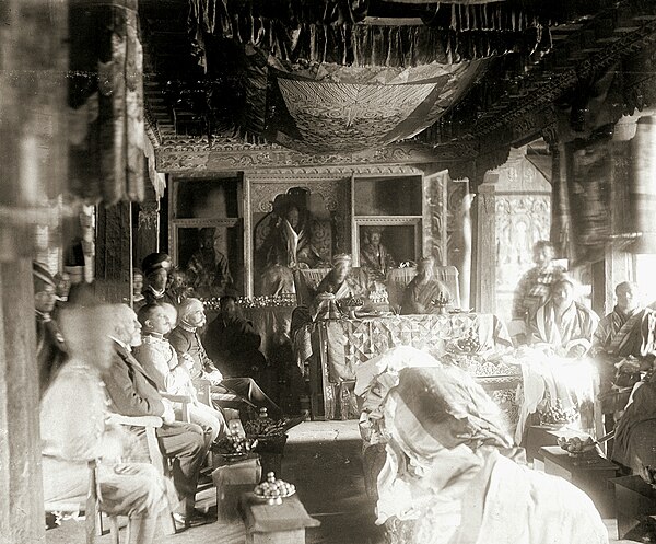 White, seated 4th on left, at the Durbar of Ugyen Wangchuck, who is receiving the order of the Knight Commander of the Indian Empire, at Punakha Dzong