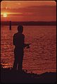 FISHERMAN AT SUNSET ON LAKE WASHINGTON AT RENTON. LAKE WASHINGTON WAS DYING OF POLLUTION CAUSED BY SEWAGE. UNDER THE... - NARA - 552224.jpg