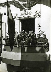 A group of falangists making the fascist salute from a city balcony in September 1936. Fotografia del Jefe Territorial de la Falange Espanola Sancho Davila y Fernandez de Celis en Sevilla saludando desde el balcon de la casa cuartel.jpg