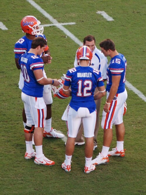 Tebow (on right, #15), Cam Newton (on far left, #13) and other Gator QBs during pre-game warm-ups