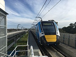 High Capacity Metro Train arriving at elevated Hughesdale station, Melbourne.
