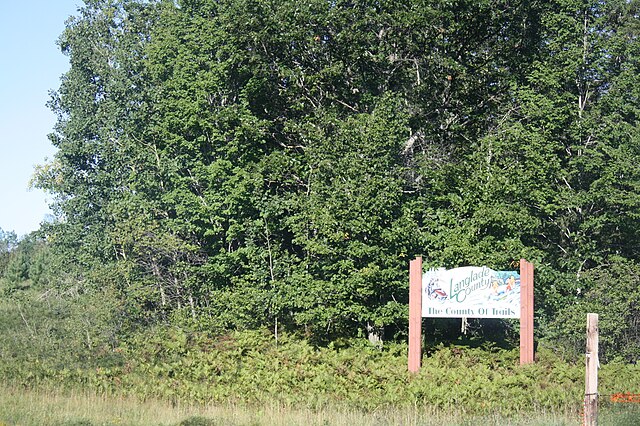 Looking north at the welcome sign for Langlade County