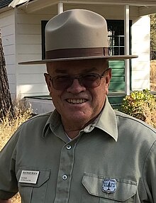 Les Joslin, in period Forest Service uniform with old forest guard badge, at the High Desert Museum's historic ranger station, 2018