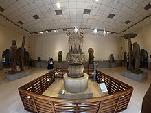 Inside view of the museum, with the Lion Capital of Ashoka at the center, and the Bala Bodhisattva to the left. Lion Capital of Ashoka 3.jpg