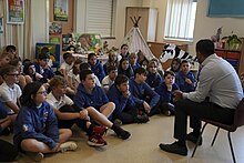 Yousaf with a group of primary school children at the launch of the Reading Schools initiative, August 2023 Next chapter for Reading Schools.jpg