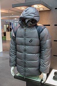Hiking: A thick, padded grey jacket with a zip and hood with conventionally stitched quilts