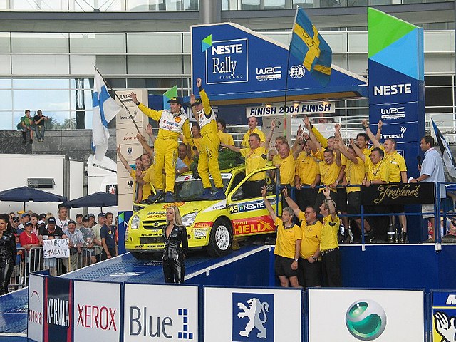 P-G Andersson and Suzuki celebrating JWRC class victory at the 2004 Rally Finland.