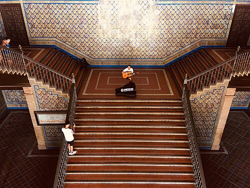 A guy playing guitar on stairs in Plaza de España in Seville, Spain