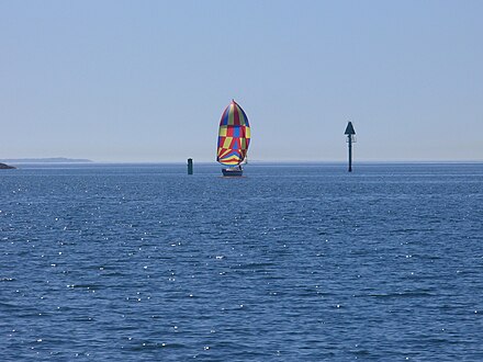 Large sheltered waters. Yacht by spinnaker in a shipping lane between Houtskär and Korpo.