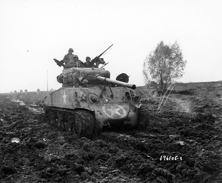 File:SC 196105-S - This M-4 medium tank is put thru the (?) in the mud by members of the Motor transport unit, near Nancy, France. 5 November, 1944.jpg