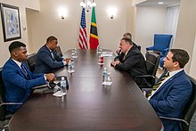 Meeting between American and Kittsian diplomats; Saint Kitts and Nevis flag in background Secretary Pompeo Meets with Saint Kitts and Nevis Foreign Affairs Minister Brantley (49429597733).jpg