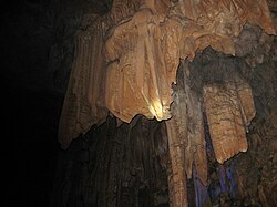 Stone curtains on display at Reed Flute Cave.JPG