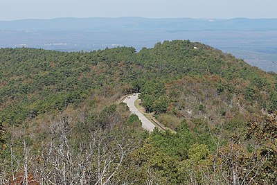 Road turning on top of a forested ridge