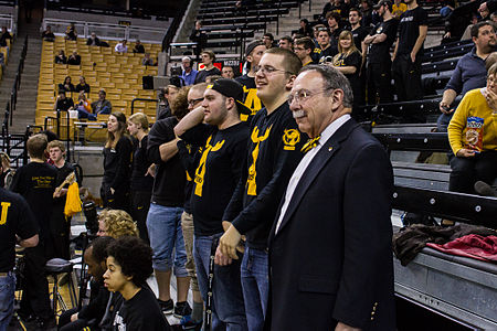 Former Chancellor R. Bowen Loftin looks on as The Antlers cheer on a women's basketball game. The Antlers and Chancellor Loftin.jpg