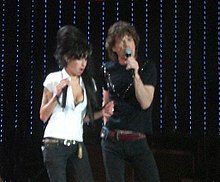Winehouse with Mick Jagger at the 2007 Isle of Wight Festival, England. After performing solo the previous night, she sang Ain't Too Proud to Beg with the Rolling Stones on 10 June.[45]