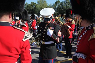 Military musicians of Canada and the United States conversing during a rehearsal for the Fortissimo Sunset Ceremony. Military music is one of the many trades for individuals in the militaries of both countries. USMC-100819-M-1394J-004.jpg