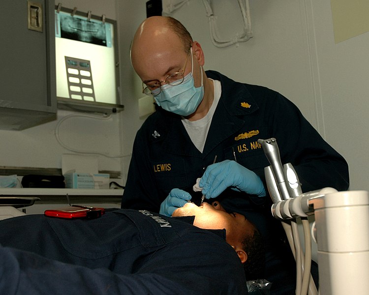 File:US Navy 070222-N-5588M-004 Capt. Michael T. Lewis performs an oral exam on an enlisted Sailor on board amphibious assault ship USS Nassau (LHA 4).jpg