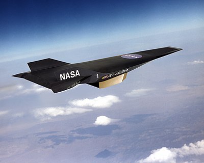 Artist's conception of black, wingless jet with pointed nose profile and two vertical stabilizers travelling high in the atmosphere.