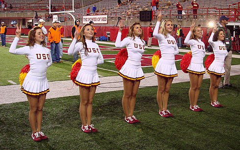 The USC Song Girls are making the traditional "V"-for-victory hand sign