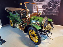 The 1905 Spyker 12/16-HP Double Phaeton that was used as Ambrose Claverhouse's car in the film Genevieve. As of 2012 this car is held in the Louwman Museum in the Netherlands. A still from the film can be seen in the background 1905 Spyker 12slash16-HP Double Phaeton photo1.JPG