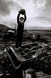 Boy destroying piano at Pant-y-Waen, South Wales, by Philip Jones Griffiths, 1961 Boy destroying piano.jpg