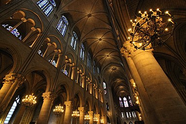 Interior view of Notre-Dame's nave wall, showing (top to bottom) clerestory window, triforium, and side aisle openings.