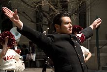 The Ouendan are a cheer squad, wearing distinctive black gaku-ran Japanese school uniforms with red armbands. Cheerleader Waseda.jpg